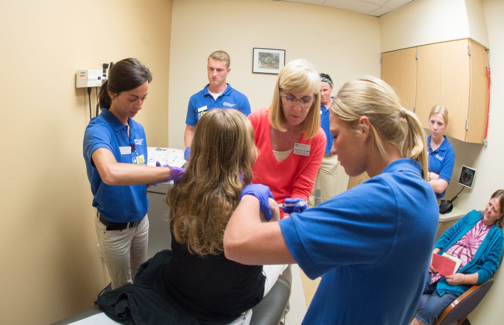 Medical scene of someone getting their immunization shot. 
