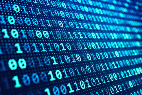 A close up photo of a screen with the numbers 0 and 1 randomly scattered across the screen in rows. They are in various shades of blue.